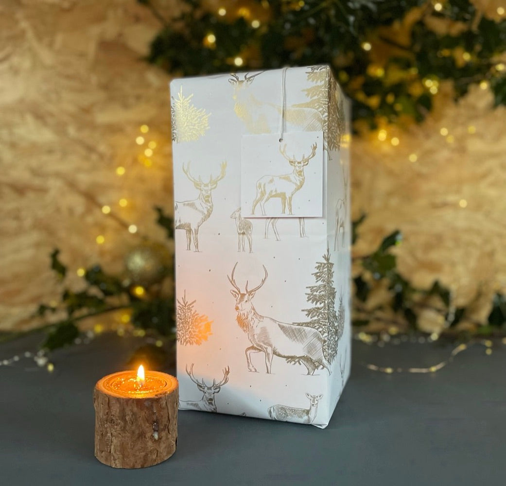 gold metallic recyclable paper made in Britain. Line drawings of stags, deer fir trees for a Christmas feel by Ceinwen Campbell