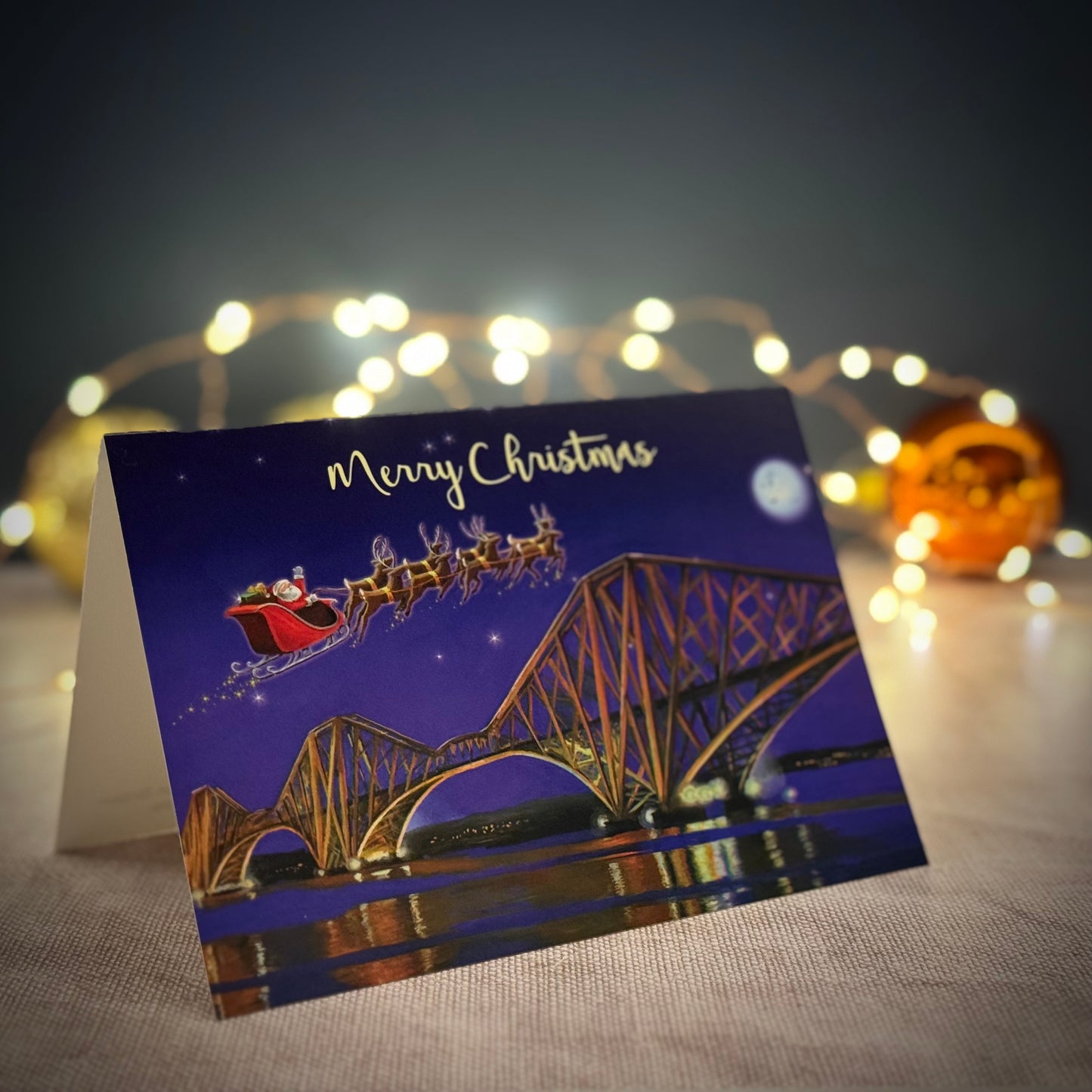 Forth Rail Bridge Christmas card with fairy lights in back ground 