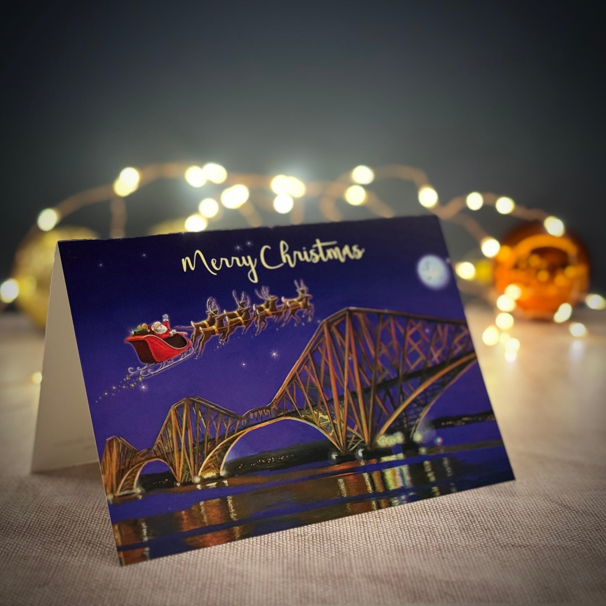 Forth Rail Bridge Christmas card with fairy lights in back ground 